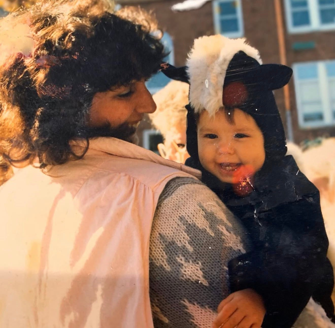 Family photograph of a woman holding a smiling child in winter clothing